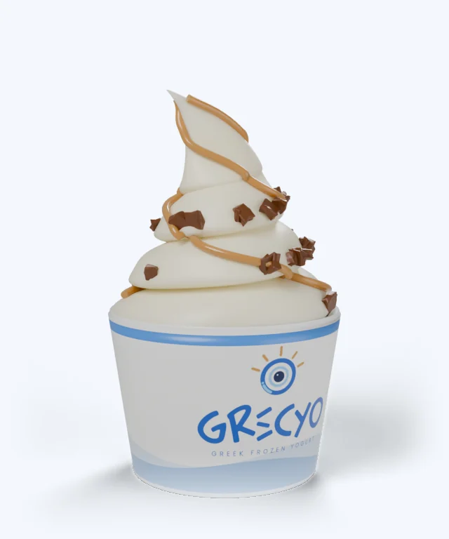 A Grekyo cup of Greek frozen yogurt with a peanut butter drizzle and chocolate crumbles